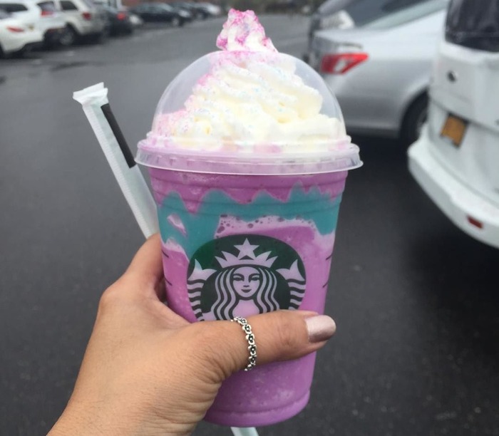 Woman holding the limited edition Unicorn Frappuccino from Starbucks